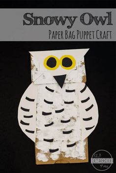 an owl paper bag puppet craft made with white and black paper on a black background