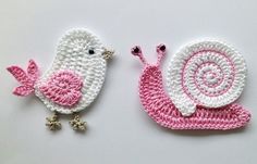 two crocheted birds sitting next to each other