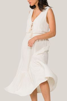 The embodiment of carefree summer spirit. Wear this breathable, versatile dress for a day on the beach, a stroll through the farmers market, or your neighbor's sunset garden party. Flowy V-neck Midi Dress For Beach, Flowy Sundress For Brunch During Beach Season, Beachy Midi Dress For Brunch During Beach Season, Breezy Sundress For Summer Garden Party, Summer V-neck Beach Dress For Garden Party, Breezy Sundress For Garden Party, Breezy V-neck Beach Dress For Daywear, Cotton Sundress For Summer Garden Party, Beachy V-neck Midi Dress For Day Out