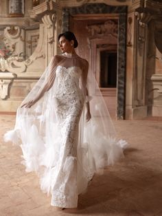 a woman in a white wedding dress and veil