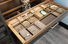 an open drawer with jewelry inside of it