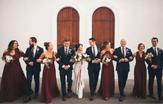 a group of people standing next to each other in front of a building with doors