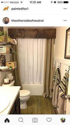 a bathroom with a toilet, sink and shower curtain in it's window sill