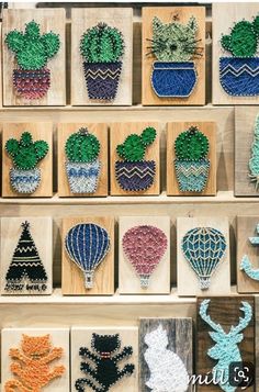 several wooden boxes with different types of bead designs on them, including hot air balloons and cacti