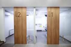 two wooden doors with numbers on them in an office