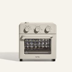 a white oven with four burners and three knobs on the front, against a white background