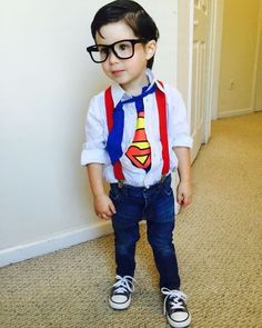 a young boy wearing glasses and a superman tie