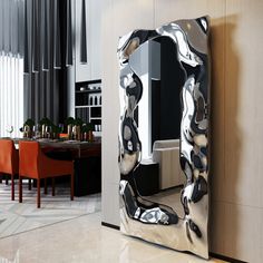 a large mirror sitting on the side of a wall next to a dining room table