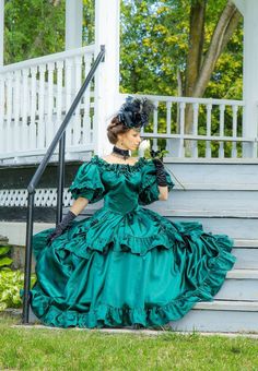 Dazzling satin gown for your next Victorian Ball! Sweetheart neckline is trimmed in ruching, ruffled trimmed puffed sleeves, deep V-shaped bodice, and fancy full double skirt are features of this ball gown. Satin rosette bows trim the center front and at each of the shirring on the overskirt. Hook and eye or zipper back closure. 100% acetate satin. Dry Clean. Designed and made by Recollections in America. Alicia is wearing gloves, hat jewelry, boots, a ruffled hoop and carrying a fan, and they a Fitted Satin Ball Gown, Fitted Satin Ball Gown Dress, Formal Satin Ball Gown With Ruffles, Satin Ball Gown For Fancy Dress, Satin Victorian Ball Gown For Costume Party, Formal Fitted Ball Gown With Ruffles, Debutante Ball Dress With Ruffled Skirt And Fitted Bodice, Victorian Satin Dress With Ruffles For Wedding, Ruffled Ball Gown With Fitted Bodice For Debutante Ball