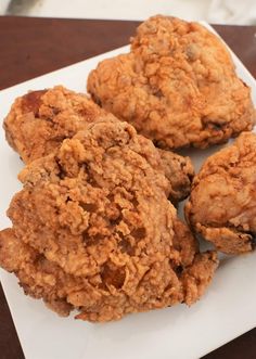 three pieces of fried food on a white plate