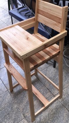 a wooden chair sitting on top of a tile floor