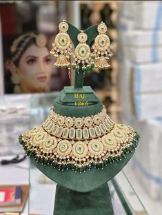 an elaborate necklace and earring set on display in a store window, with the price tag