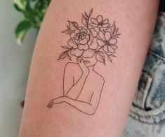 a woman with a bouquet of flowers on her head is shown in this tattoo design