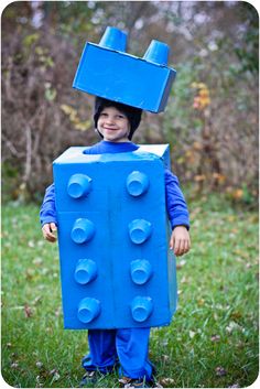 a young boy in a costume made out of lego blocks