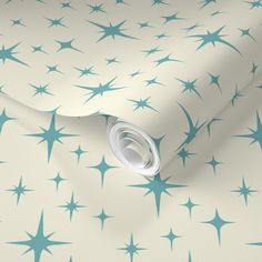 a white and blue star wallpaper with stars on the background, as well as a roll of paper