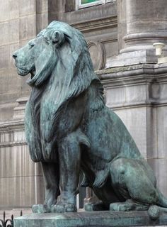 a statue of a lion sitting in front of a building