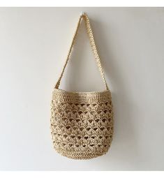 a crocheted purse hanging on the wall