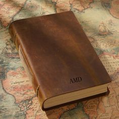 an old book with the word amd written on it sitting on a world map