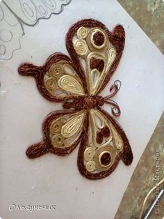 a close up of a butterfly on a piece of paper with scissors in the background