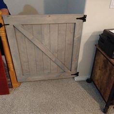 an old wooden door is open in the corner of a room next to a dresser