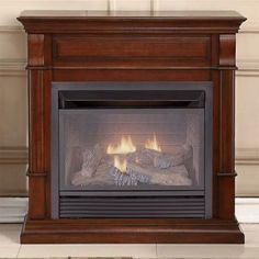 an image of a fireplace that is in the living room with it's logs burning