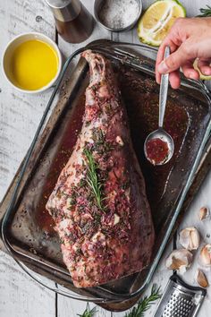 someone is cutting up a piece of meat on a pan