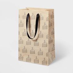 a brown paper bag with black handles