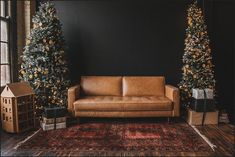 a living room with christmas trees and couches