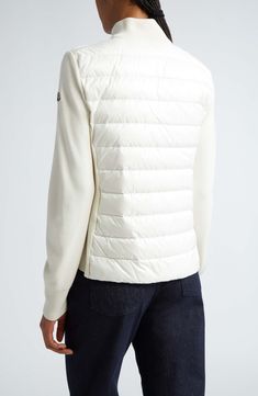 Part puffer, part cardigan, this hybrid style with a stand collar combines virgin-wool knit sleeves with a down-filled quilted nylon core. Two-way front-zip closure Stand collar Long sleeves with ribbed cuffs Partially lined, with down fill 100% polyamide with 100% virgin wool contrast Dry clean Imported Designer Clothing White Turtleneck Outerwear With Ribbed Cuffs, White Wool Turtleneck Outerwear, Navy Jacket Women, Navy Quilt, Designer Clothing Brands, Womens Quilted Jacket, Moncler Women, Quilt Jacket, Knit Sleeve