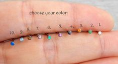 a person's hand holding a tiny bead chain with the words choose your color on it