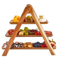 three tiered wooden food display with cheeses and fruits