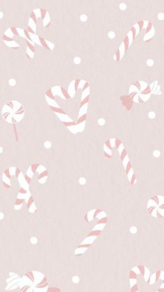 pink and white candy canes on a light pink background with polka dotes for wallpaper