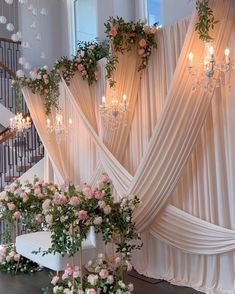 an elegant wedding setup with flowers and chandeliers