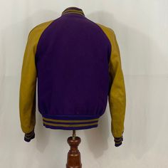 "True vintage from 1961 Purple and Gold letterman jacket- also know as a varsity jacket From Hatcher's per the tag in the pocket Not sure what school this was from but \"G\" It is literally reversible- SURPRISE!- guess after you graduated high school you could reverse it and wear it to work Sold AS IS so please ask questions Condition- good for its age Exterior -Leather sleeves in good condition- they could use some conditioning but not our forte -Wool is in great condition Interior shows wear - Vintage Fall Sport Coat With Double-needle Stitching, Vintage Sport Coat With Double-needle Stitching For Fall, Vintage Cotton Outerwear With Baseball Collar, Retro Fall Outerwear For Campus, Vintage Cotton Varsity Jacket With Pockets, Vintage Cotton Varsity Jacket For College, Retro Outerwear For Sports Events In Winter, Retro Cotton Varsity Jacket For College, Retro Cotton Varsity Jacket For School