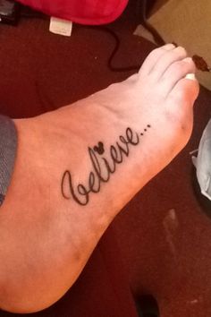 a person with a tattoo on their foot that says'believe'in cursive writing