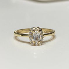 Vintage 14K Solid Yellow Gold White Topaz Ring....Marked 14K...Total of weights 1.8grams... Size 8Measure of Face 8.0MMIt's in very good condition. 14k Gold Halo Ring With Emerald-cut Center Stone, 14k Gold Emerald Cut Halo Ring With Center Stone, 14k Gold Radiant Cut Rings For Anniversary, 14k Gold Emerald-cut Cluster Ring With Halo Design, 14k Gold Emerald-cut Halo Cluster Ring, 14k Gold Emerald Cut Cluster Ring With Halo Design, 14k Gold Emerald Cut Halo Cluster Ring, Gold Topaz Ring With Halo Setting In 14k Gold, Luxury 14k Gold Crystal Promise Ring With Center Stone