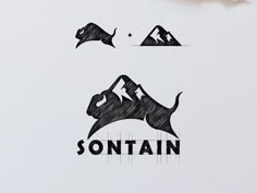 some type of logo with mountains in the background