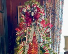 a christmas tree decorated with ribbons and lights