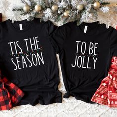 two t - shirts that say holly and jolly on them next to a christmas tree