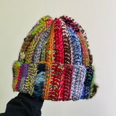 a person wearing a multicolored knitted hat