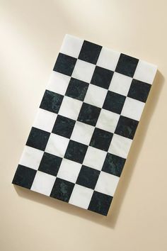 a black and white checkerboard tile on the wall