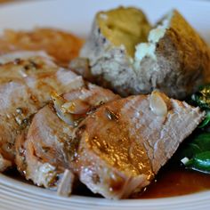 a white plate topped with meat and vegetables