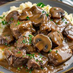 a plate with mashed potatoes, mushrooms and gravy