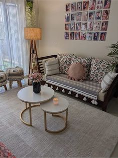 a living room filled with furniture and pictures on the wall