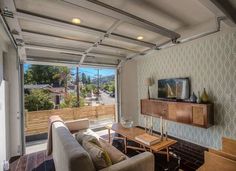 a living room filled with furniture and a sliding glass door