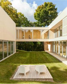 an empty lawn with two white chairs on it