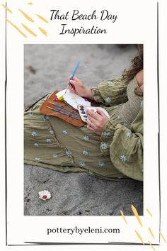 a woman is sitting on the beach writing in her notebook and holding a pencil, with text overlay reading that beach day inspiration