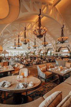 the inside of a restaurant with chandeliers hanging from the ceiling