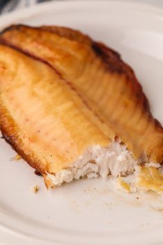 a partially eaten banana sitting on top of a white plate