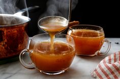 liquid being poured into a glass tea pot